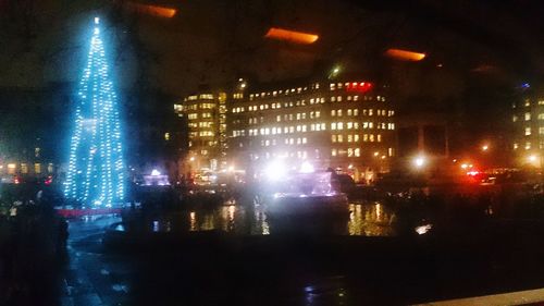 Illuminated city street at night