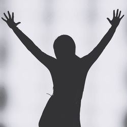 Low angle view of silhouette hand against sky