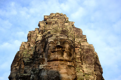 Low angle view of sculpture in temple against sky