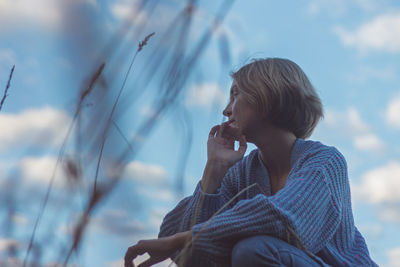 Low angle view of woman dancing against sky