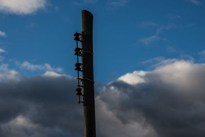 Low angle view of communications tower against sky