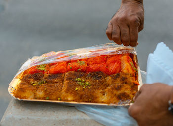 Cropped hand of person preparing food