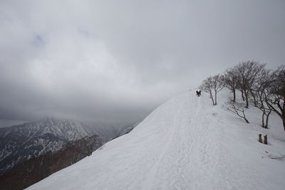 Scenic view of snow covered mountain against sky