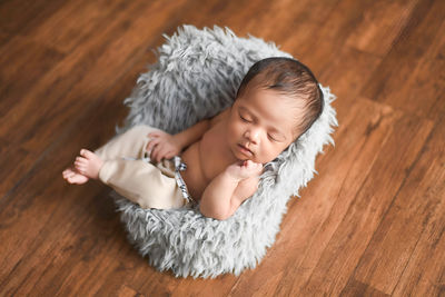 Portrait of young woman sitting on hardwood floor