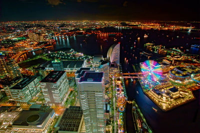 High angle view of illuminated buildings in city at night