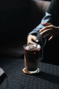 Midsection of woman holding wineglass