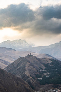 Scenic view of mountains against cloudy sky