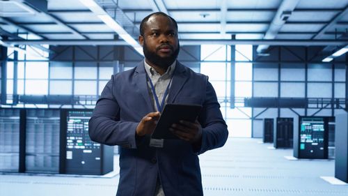 Portrait of young man standing in office