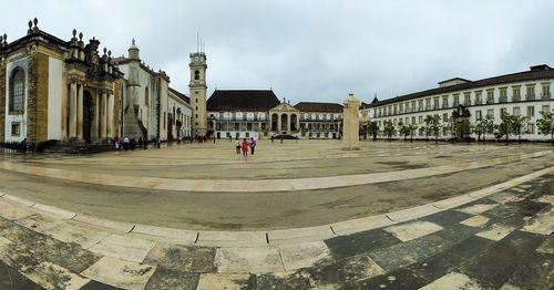 Buildings against cloudy sky