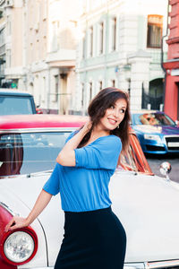 Portrait of a smiling young woman in city