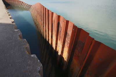 High angle view of wooden posts on beach against sky