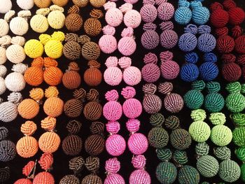 Full frame shot of colorful earrings for sale at market