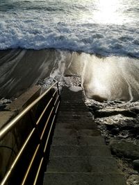 Sea waves splashing on staircase