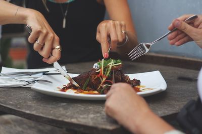 People eating food on table at home