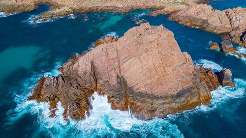 High angle view of rocks in sea