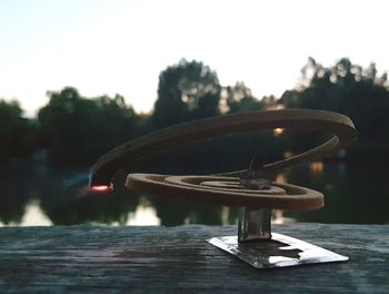 Close-up of skateboard on table against sky