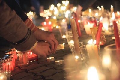 Illuminated candles burning in temple