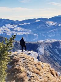 Rear view of man on mountains against sky