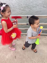 Cute girl holding while standing in water