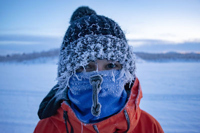 Portrait of woman wearing knit hat standing in winter outdoors