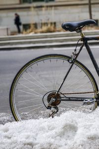 Close-up of bicycle on snow covered field