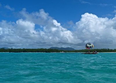 Boat sailing in sea against sky