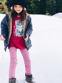 Portrait of teenage girl standing in snow