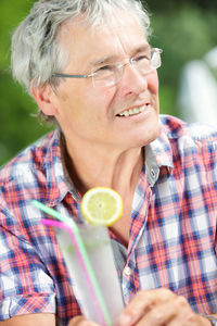 Smiling man holding cocktail glass