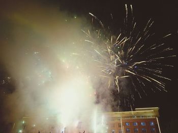 Low angle view of firework display at night