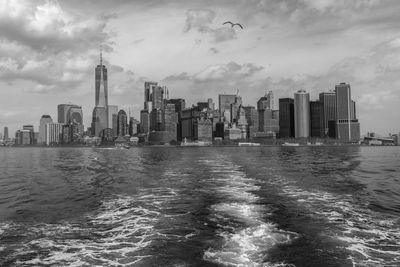 Panoramic view of sea and buildings against sky