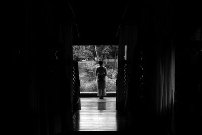 Rear view of a man standing in corridor