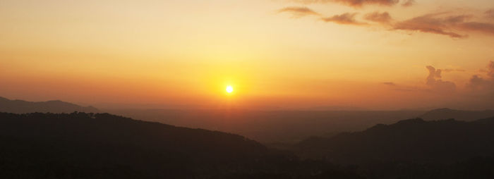 Scenic view of silhouette mountain against sky during sunset