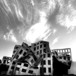 Low angle view of building against cloudy sky