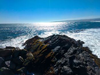 Scenic view of sea against blue sky