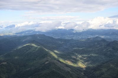 Aerial view of mountain range against cloudy sky