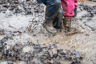 Low section of man working in mud