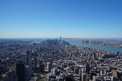 Aerial view of city against blue sky