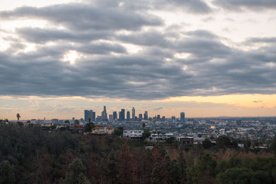 View of cityscape against dramatic sky