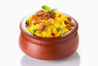 Close-up of pasta in bowl against white background