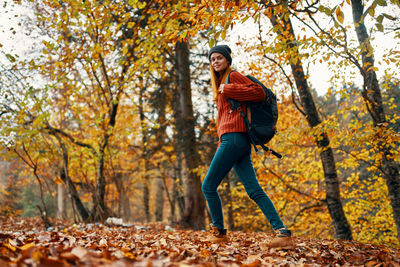 Portrait of smiling man in forest during autumn