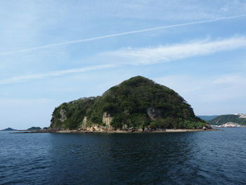 Scenic view of sea and mountains against sky