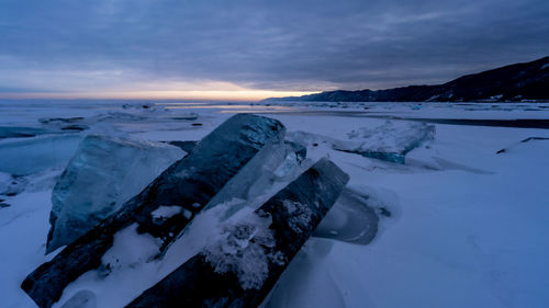 Scenic view of snowcapped mountains against sky during sunset. baykal.