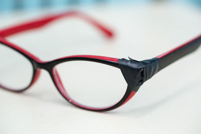Close-up of eyeglasses on white table
