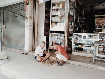 High angle view of woman sitting in abandoned building