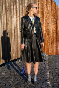 Low section of woman standing on footpath