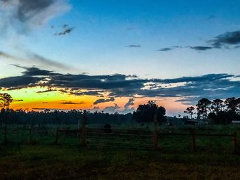 Scenic view of field against sky during sunset