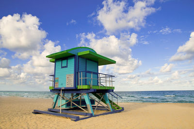 Lifeguard hut on beach against sky