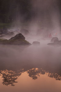 Scenic view of lake against sky during foggy weather