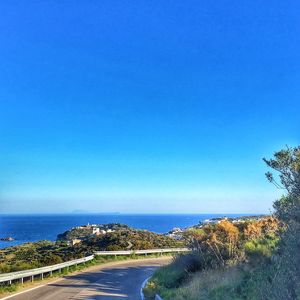 Scenic view of beach against clear blue sky