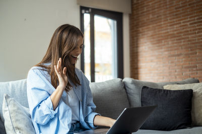 Young woman using laptop at home